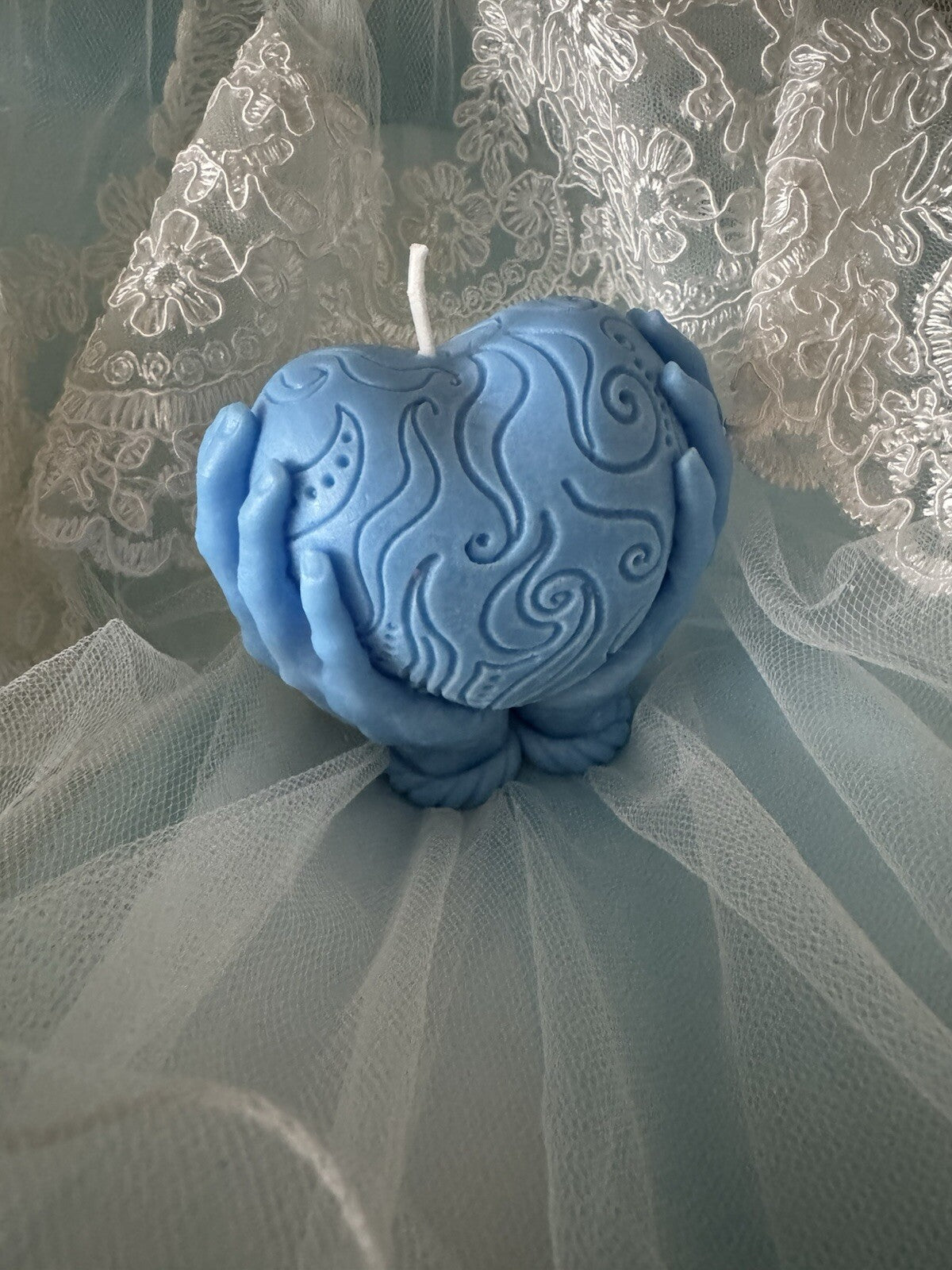 Scented vanilla candle blue heart holding